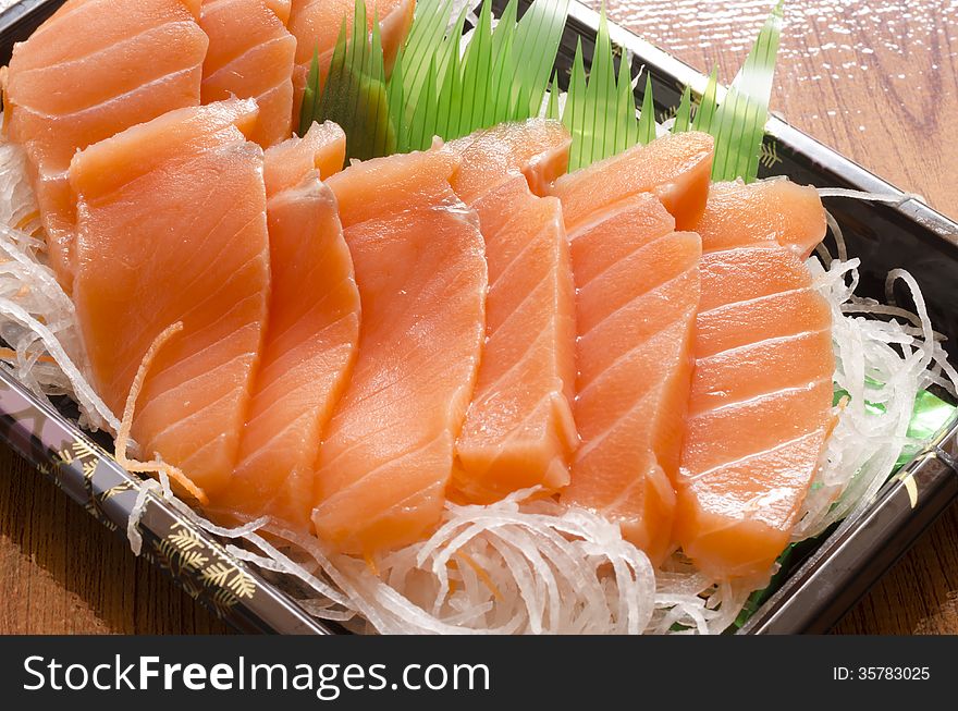 Fresh salmon piece for sushi on wood background. Fresh salmon piece for sushi on wood background