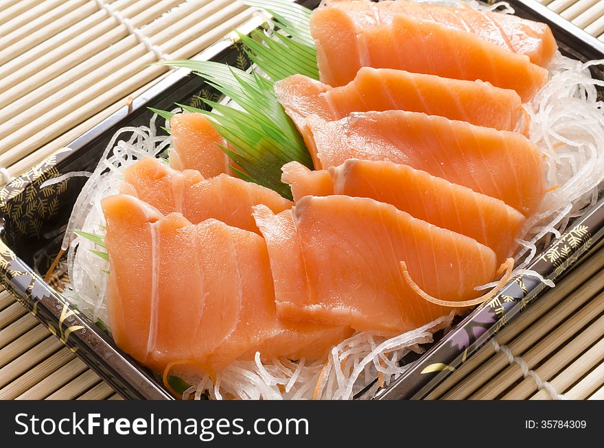 Fresh salmon piece for sushi on wood background. Fresh salmon piece for sushi on wood background