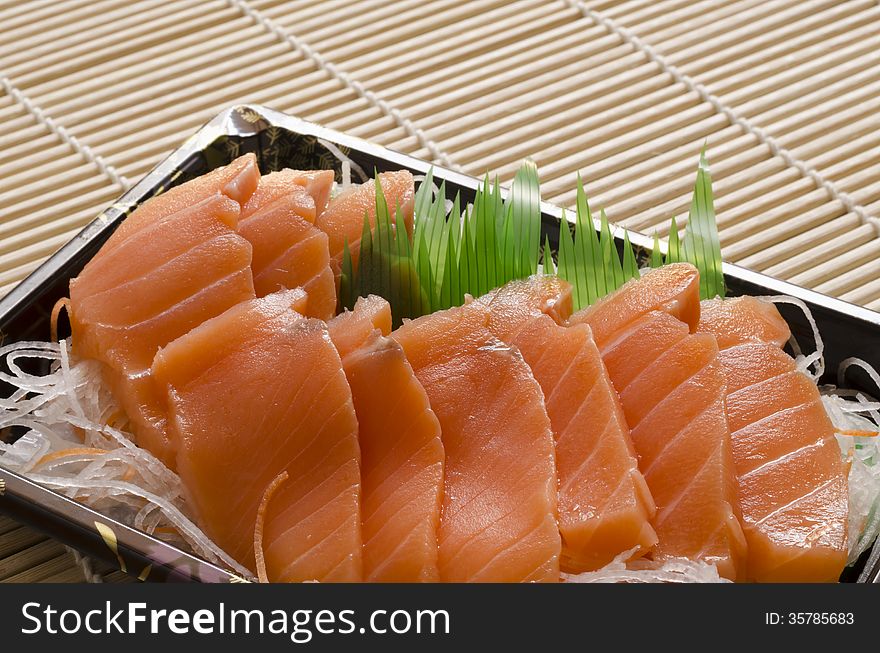 Fresh salmon piece for sushi on wood background. Fresh salmon piece for sushi on wood background