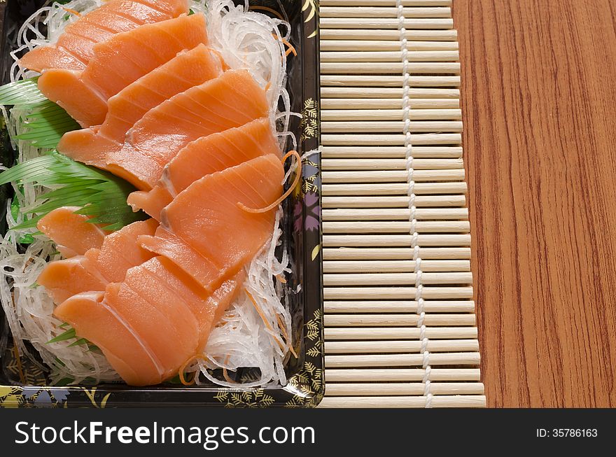 Fresh salmon piece for sushi on wood background. Fresh salmon piece for sushi on wood background