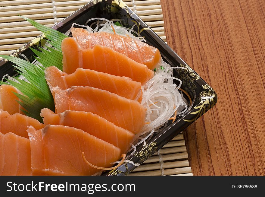 Fresh salmon piece for sushi on wood background. Fresh salmon piece for sushi on wood background