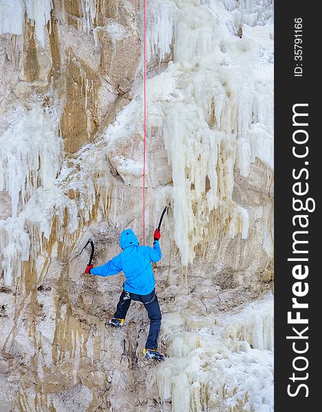 Young Man Climbing The Ice