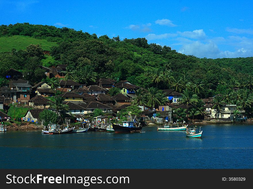 A beautiful landscape of a lake & various colourful houses on the shore. A beautiful landscape of a lake & various colourful houses on the shore