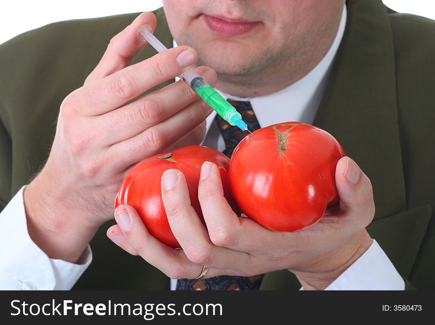Scientist injecting tomatoe with hormone growth