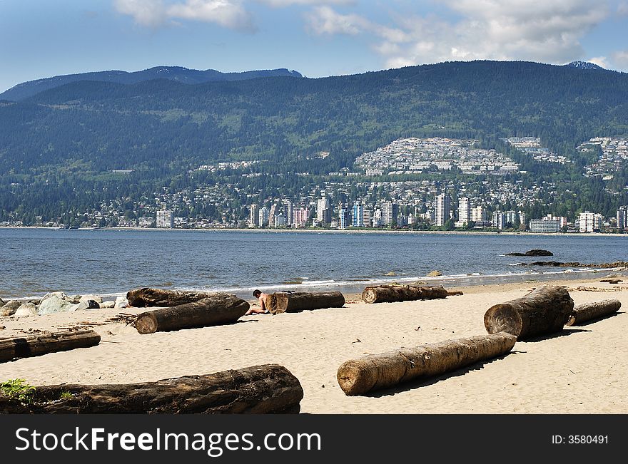 The view of Stanley's park beach with East Vancouver in a background (British Columbia, Canada).