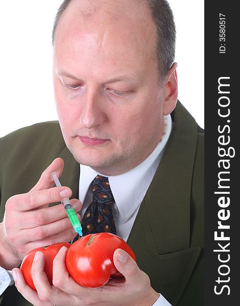 Scientist injecting tomatoe with hormone growth