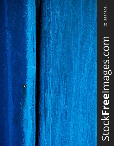 Image shows a blue wooden surface, photographed close-up in Greece