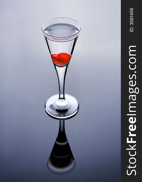 Shot glass with wodka and cherry. Shot glass with wodka and cherry