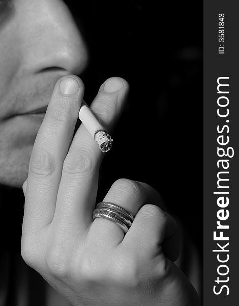 Men smoking cigarette, white and black photo. Men smoking cigarette, white and black photo