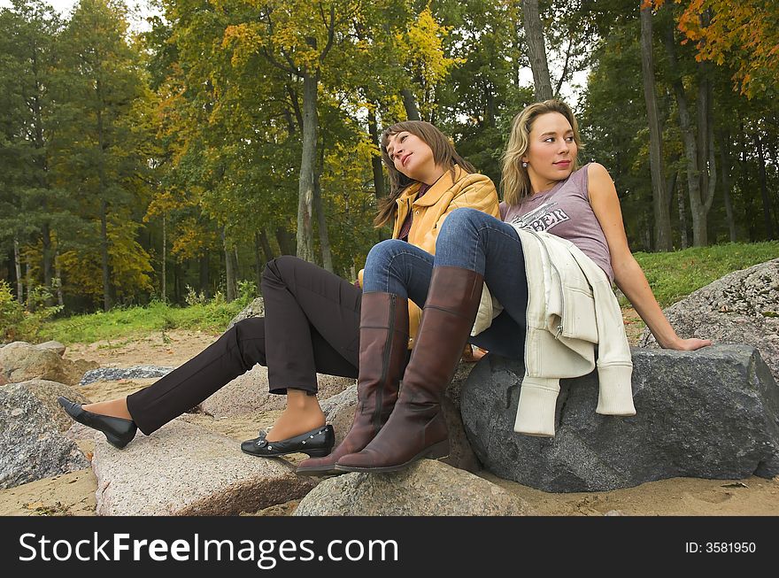Two girls having a rest in autumn park. Two girls having a rest in autumn park
