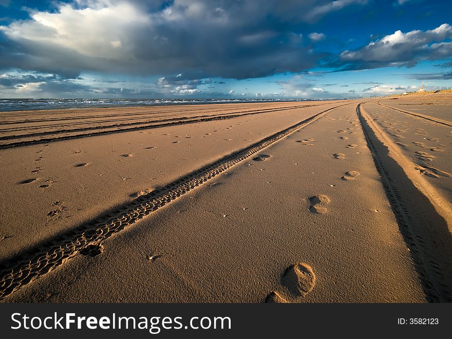 Tracks and footsteps on the beach