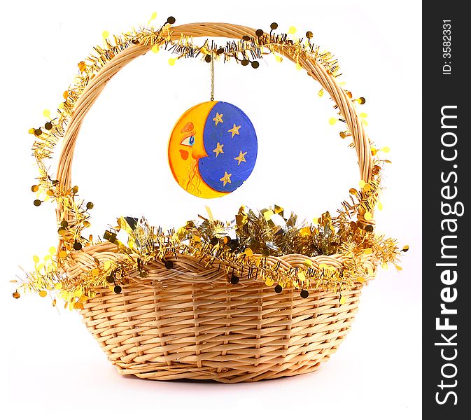 Wooden moon attached to string to the present basket witha a gold garland. Wooden moon attached to string to the present basket witha a gold garland