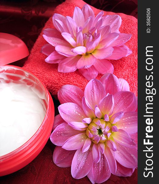 Cosmetic moisturizing cream and towel with flowers