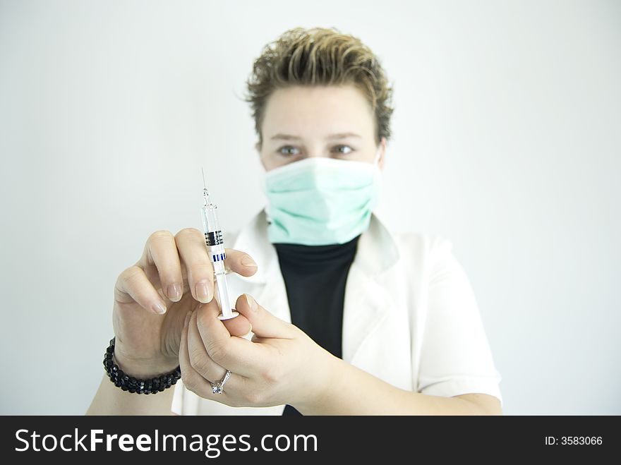 Young female doctor preparing injection