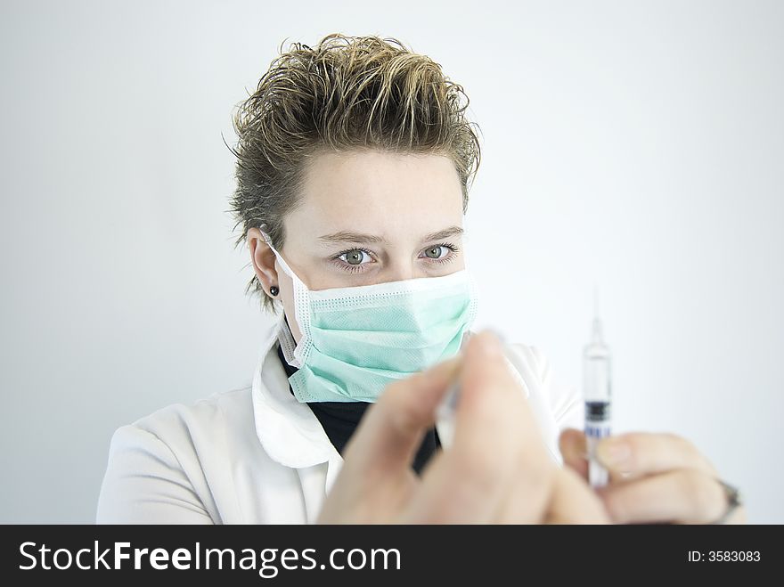 Young female doctor preparing injection