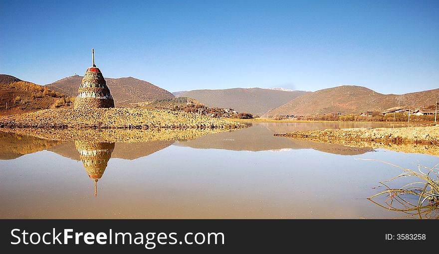 The lake with Tibet style tower have peace and mysterious feeling.