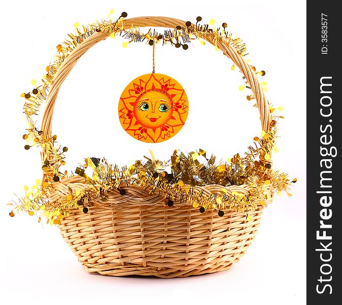 Wooden sunny attached to string to the present basket with a gold garland. Wooden sunny attached to string to the present basket with a gold garland