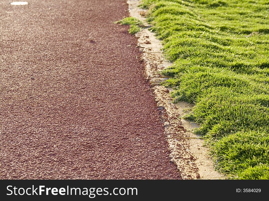 Abstract background showing part of the ground and the grass covering the football court... Shallow depth of field. Abstract background showing part of the ground and the grass covering the football court... Shallow depth of field...