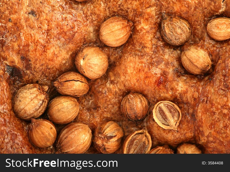 Crust of bread with seeds of a coriander, background. Crust of bread with seeds of a coriander, background