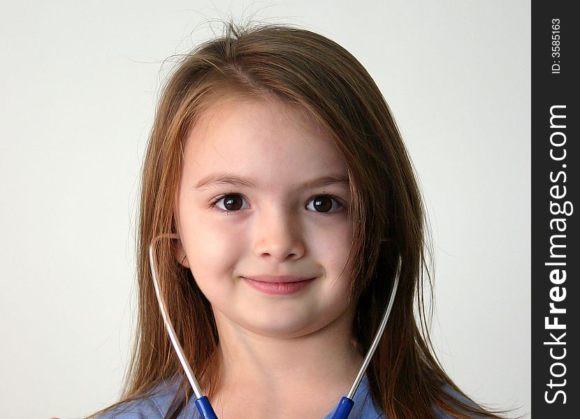 Little girl dressed in scrubs with stethoscope. Little girl dressed in scrubs with stethoscope