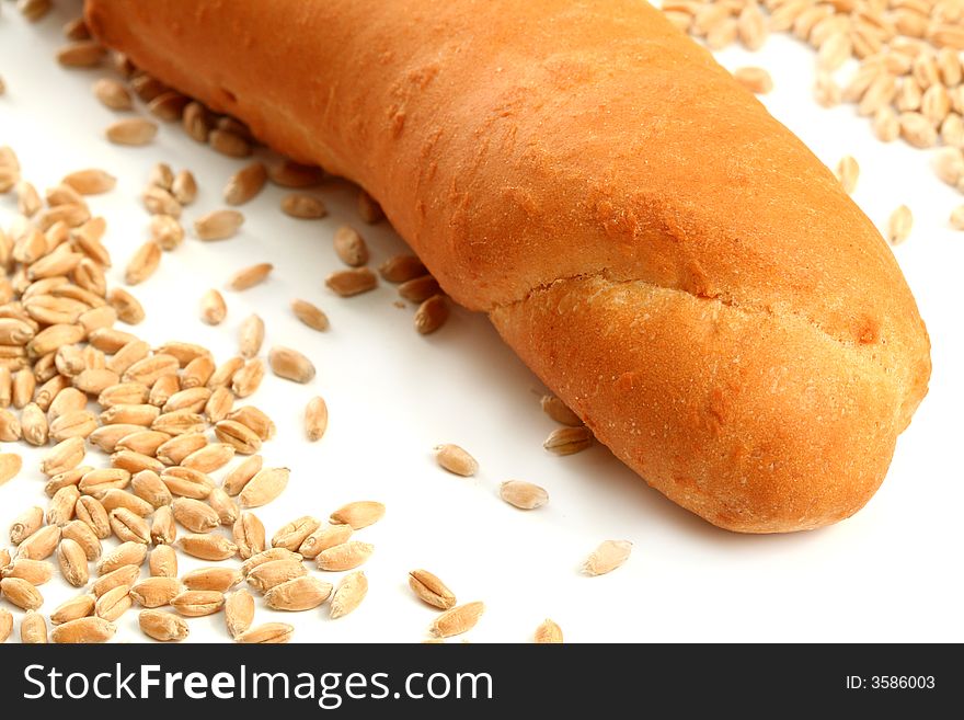 Fresh bread and seeds of wheat, isolated on white