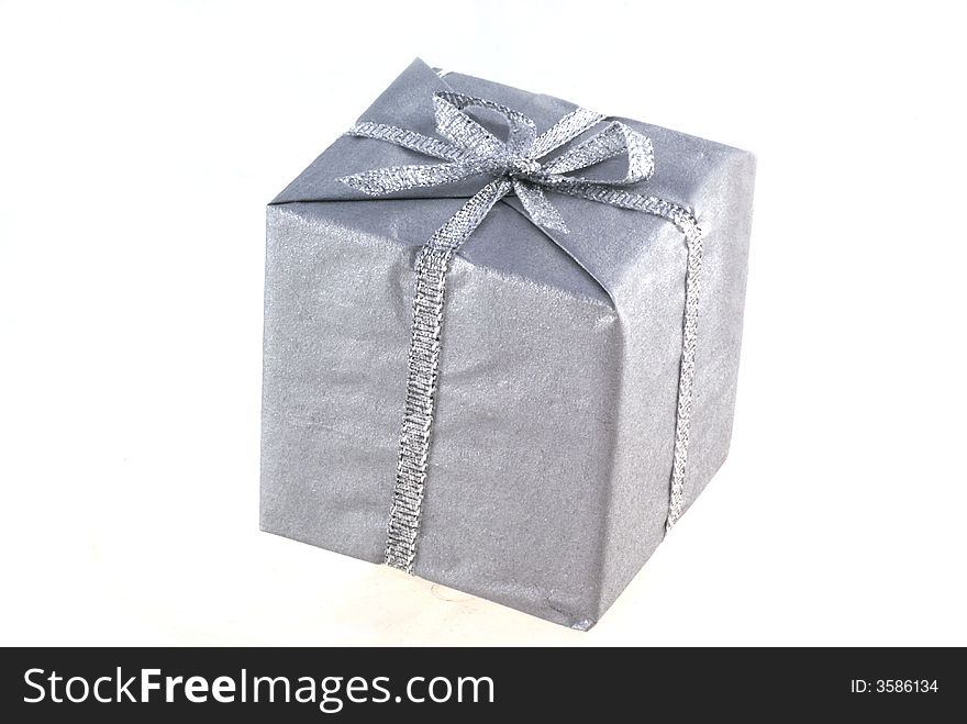 Present wrapped in silver paper isolated on white. Present wrapped in silver paper isolated on white.