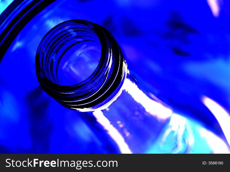 Mouth and neck of cobalt blue bottles with reflections