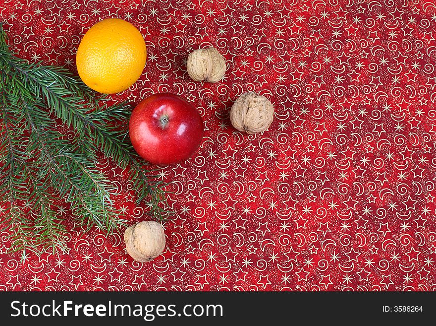 Red christmas background with pine and fruits