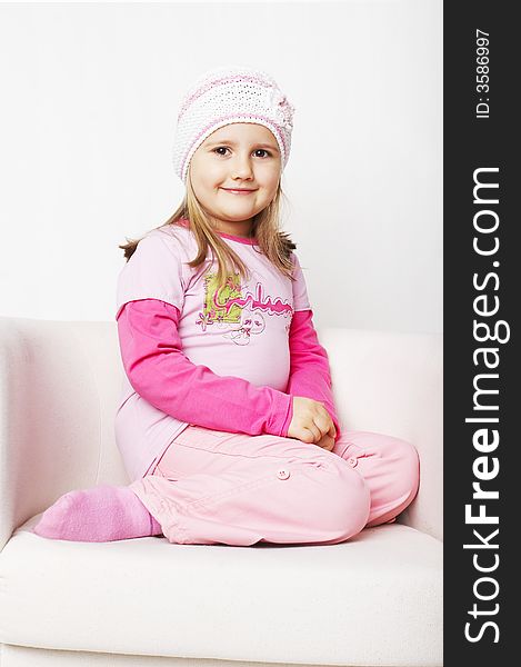 Nice young girl in pink on light background