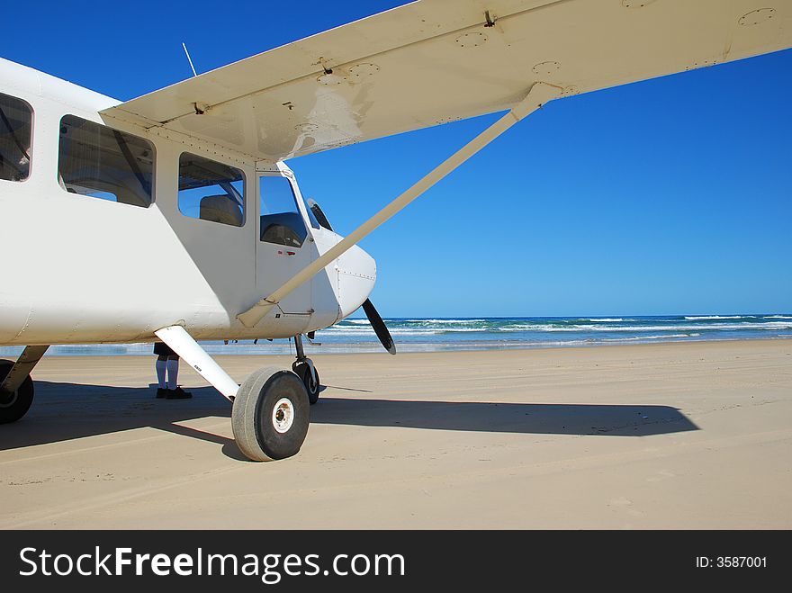 A light aircraft on a beach. ready to take off. A light aircraft on a beach. ready to take off