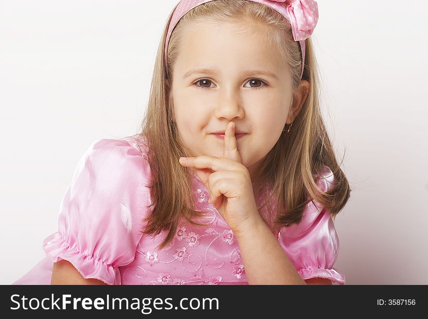 Nice young girl in pink on light background