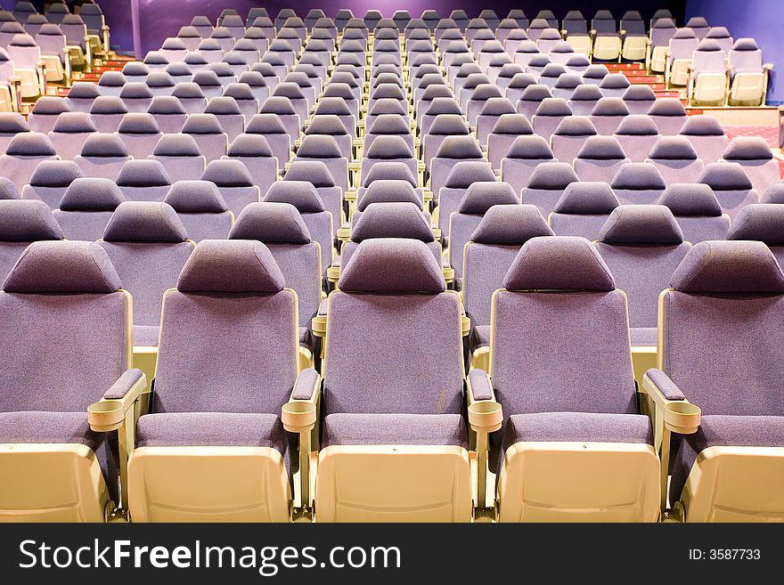 Empty cinema auditorium with blue chairs