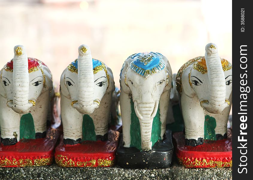 Tiny white elephant statues in a row. Tiny white elephant statues in a row.