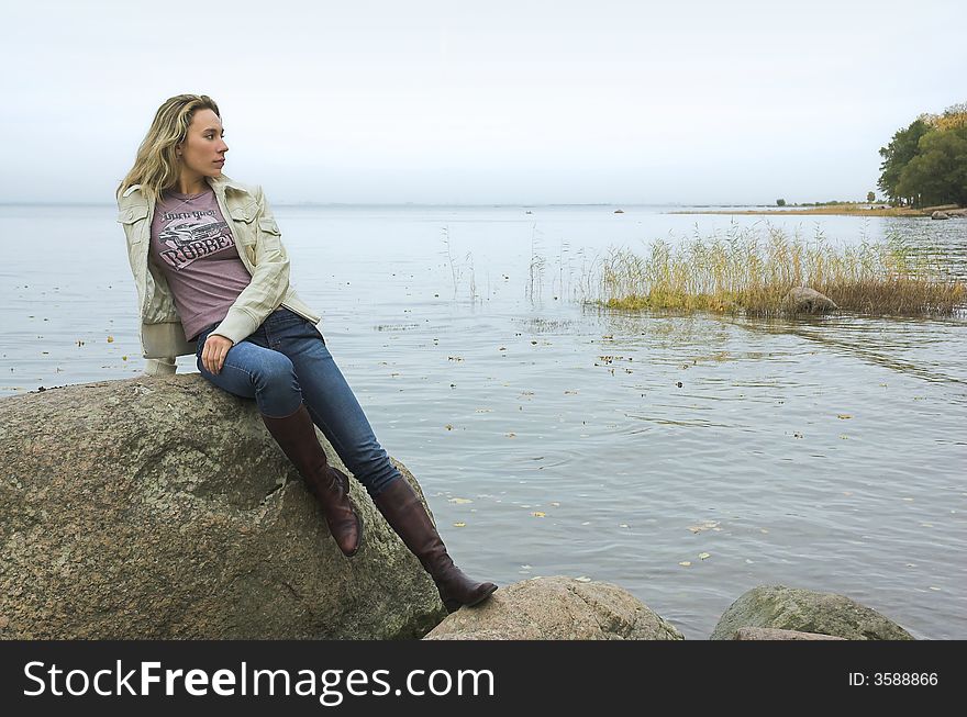 The beautiful girl has a rest on coast