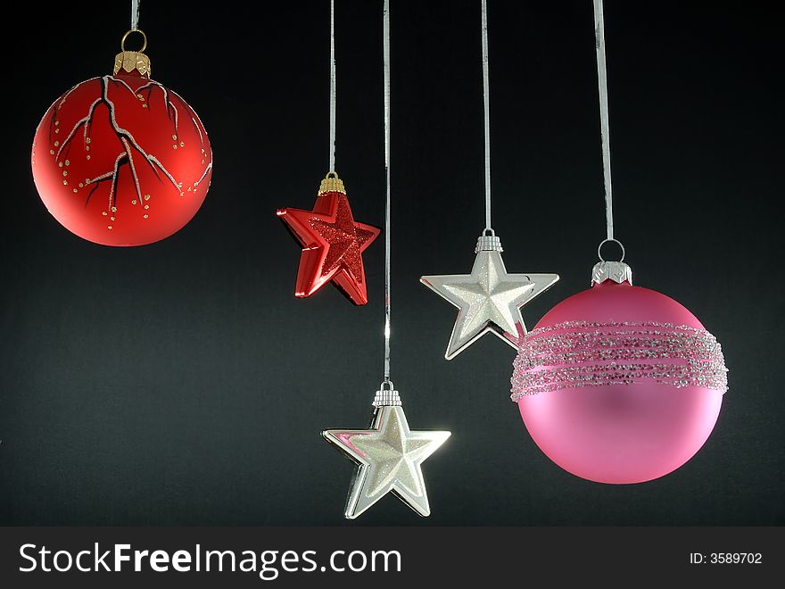 Hanging christmas tree ornaments on black background. Hanging christmas tree ornaments on black background