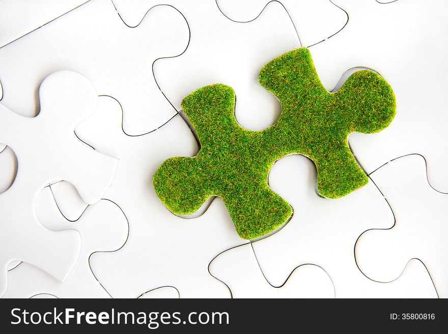 Green puzzle piece, green space concept