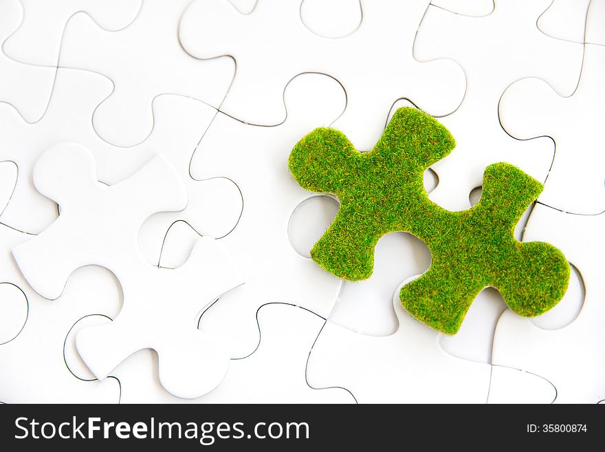 Green puzzle piece, green space concept