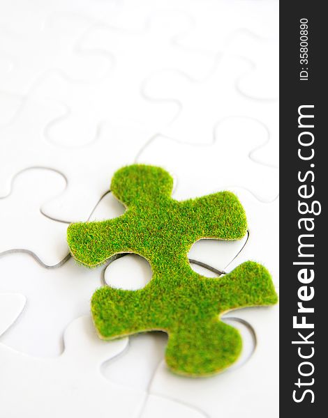 Green puzzle piece, green space concept