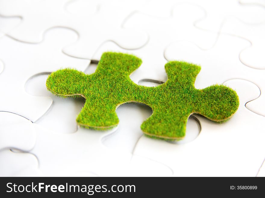 Green puzzle piece, green space concept