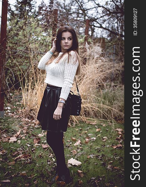 Young woman with silver jewelary on hand in white sweater. Young woman with silver jewelary on hand in white sweater