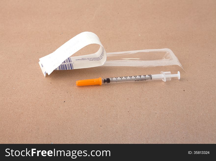 A syringe with its open wrapper.