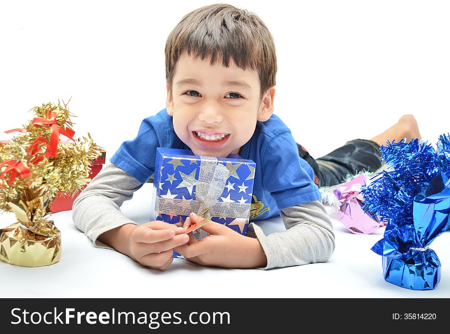 Little boy happy with new year gift on white background