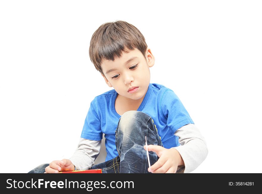 Little boy sit sad moody on white background