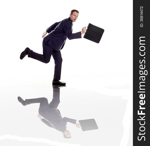 A businessman running with a briefcase on a white background. A businessman running with a briefcase on a white background.
