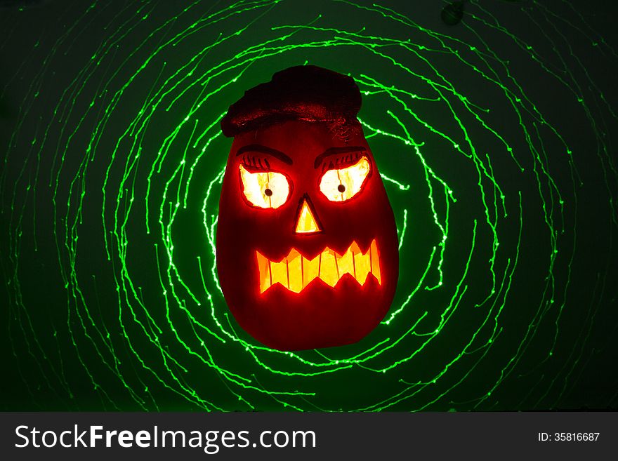 Pumpkin lit for halloween a laser light backgraund. Pumpkin lit for halloween a laser light backgraund