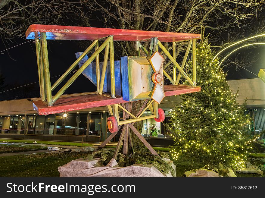 Wooden art airplane decorating a building for Christmas