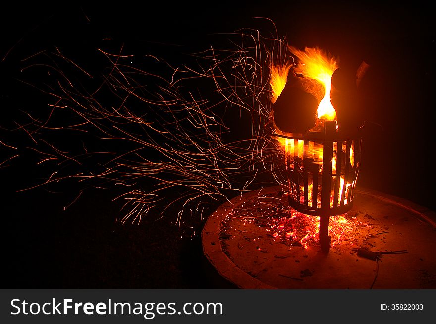 A shower of orange sparks blows off a burning campfire in South Africa. A shower of orange sparks blows off a burning campfire in South Africa