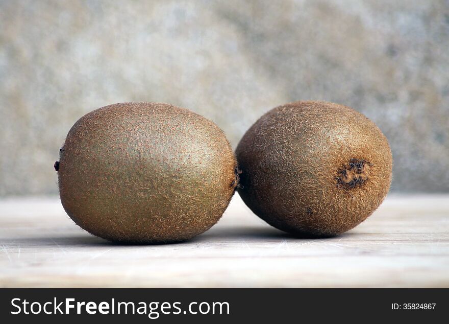 Two ripe kiwi fruit on studio background.