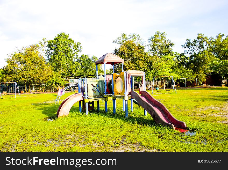 Playground Park On Grass Near School Is Children