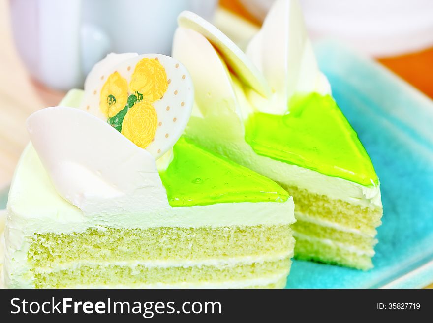 Sweet cake with flower and green cream. Sweet cake with flower and green cream